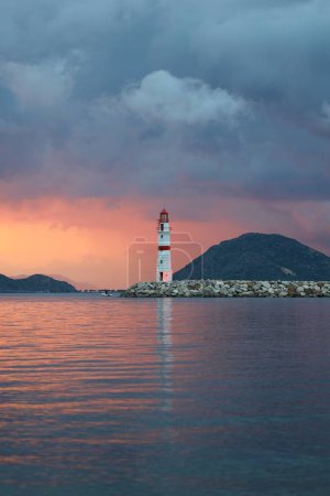 Photo for Seascape at sunshine. Lighthouse and sailings on the coast. Seaside town of Turgutreis and spectacular sunshine - Royalty Free Image