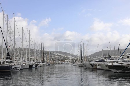 Photo for Bodrum,Turkey. 10 March 2023: Sailboats and yachts reflecting on the calm waters of the Bodrum,   Marina where people can dock their boats and ride out to sea - Royalty Free Image