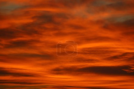 Blurry background of red sunset sky. Dramatic sky with colorful cloud background. Red burning sunset sky. Copy space.