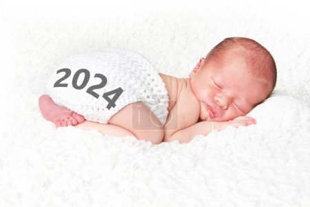 2024 Happy New Year baby. Newborn infant asleep on a white blanket. 
