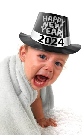 Photo for Ten month old baby boy crying and wearing a happy New Year top hat. 2024 - Royalty Free Image