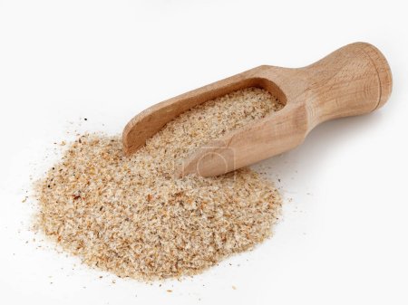 heap of psyllium husk in wooden scoop isolated on white background, Plantago Indica seed pods for use as fiber for the keto diet.