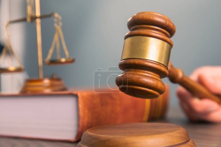 Téléchargez les photos : Law and justice concept, lawer holding document with wooden gave - en image libre de droit