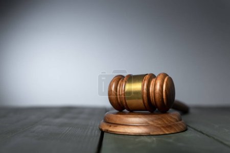 Judge gavel on table on gray backgroun