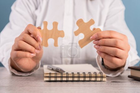 Woman Skillfully Joins puzzle Wooden Pieces, Symbolizing Problem Solving and Progress