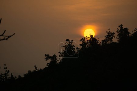 Photo for Beautiful sunrise view. Clouds on one side and the sun rising over the mountains on the other. Hilly region of Bangladesh. Photo taken from Meghbari, Bandarban, Bangladesh. - Royalty Free Image