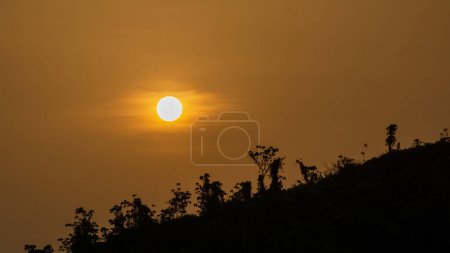 Photo for Beautiful sunrise view. Clouds on one side and the sun rising over the mountains on the other. Hilly region of Bangladesh. Photo taken from Meghbari, Bandarban, Bangladesh. - Royalty Free Image