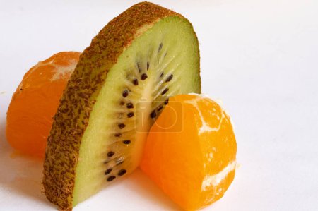 Photo for Slice of kiwi with tangerines white background - Royalty Free Image