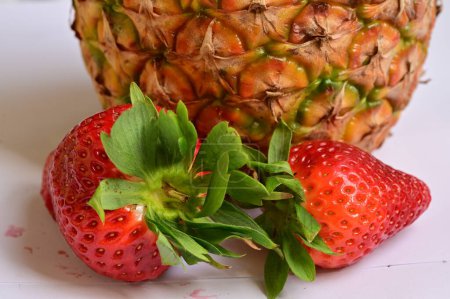Photo for Close up of fresh raw pineapple fruit and strawberries - Royalty Free Image