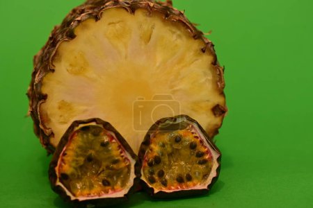 Photo for Passion fruit, pineapple, fresh fruits on green background - Royalty Free Image