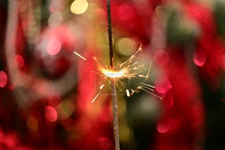 Photo for Christmas sparkler on festive background - Royalty Free Image