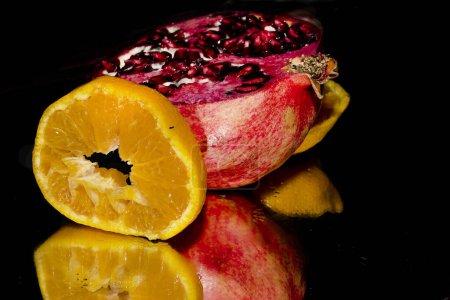 Photo for Pomegranate, orange, fresh ripe fruits on a black background - Royalty Free Image