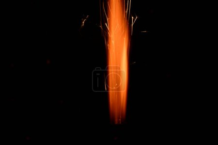 Photo for Burning sparkler on blurred festive christmas background - Royalty Free Image