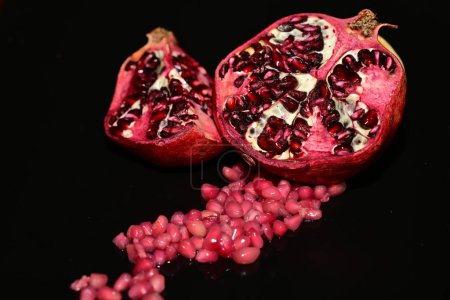 Photo for Pomegranate with seeds on a dark background - Royalty Free Image