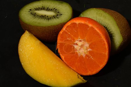 Photo for Sliced fruit on a black background - Royalty Free Image