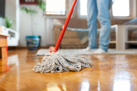 Photo for Person is washing parquet floor with mop, close-up. Bottom view. Cleaning service. - Royalty Free Image