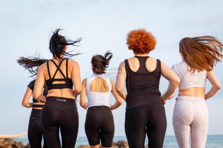 Photo for Wellness. Rear view of group of jogging women. Close up of backs. Concept of healthy lifestyle and cardio fitness class. - Royalty Free Image