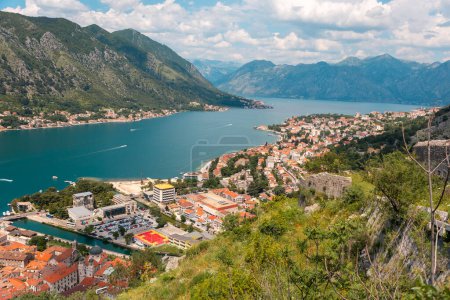 Panoramic view of Boko Kotor Bay and old town. Landscape with beautiful mountains, sea and clouds. Summer vacation at resort of Montenegro.
