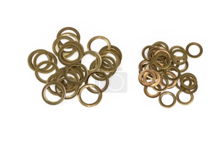 Photo for Two heaps of the metal rings different sizes as eyelets components for their installation, top view on a white background - Royalty Free Image