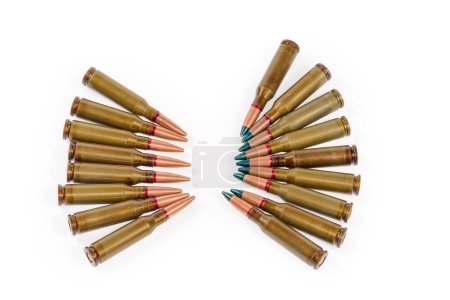 Photo for Tracer service rifle cartridges with green marking of the bullet tips and the conventional cartridges the same caliber on a white background - Royalty Free Image