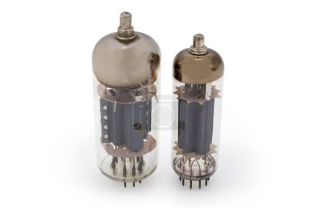 Photo for Two different old electronic vacuum tubes with top caps connections for higher voltages on the anodes are stand on a white background - Royalty Free Image