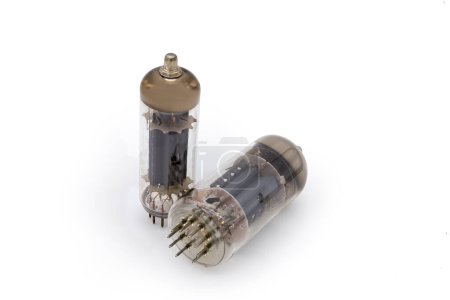 Photo for Two different old electronic vacuum tubes with top caps connections for higher voltages on the anodes on a white background - Royalty Free Image