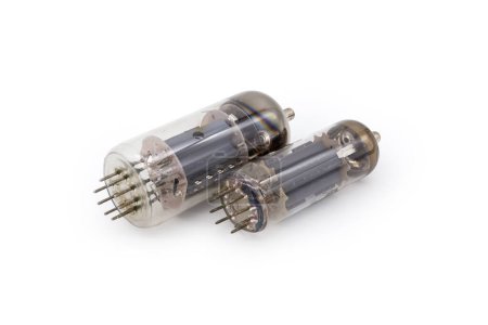 Photo for Two different old electronic vacuum tubes with top caps connections for higher voltages on the anodes are lie on a white background - Royalty Free Image