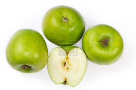 Photo for Ripe whole green apples from different sides and half of the same apple on a white background, top view - Royalty Free Image