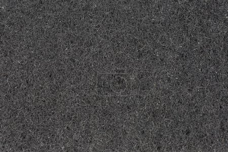 Téléchargez les photos : Texture du matériau synthétique noir de l'éponge de nettoyage abrasive à l'uréthane dur de cuisine, vue de dessus gros plan - en image libre de droit
