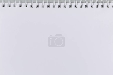 Photo for Blank white sheet of school exercise book or paper notebook with wire spiral binding, top view - Royalty Free Image