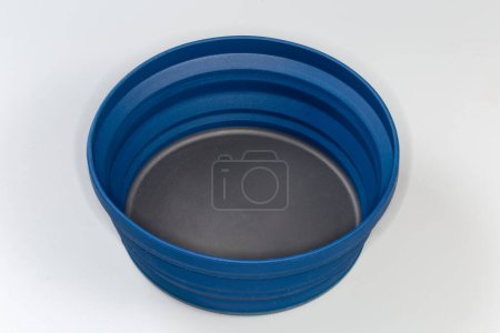 Photo for Empty tourist foldable bowl made of food-grade flexible thermosilicone in the unfolded state on a gray surface - Royalty Free Image
