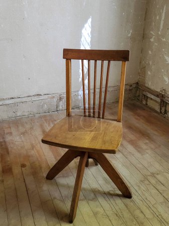 Photo for Wooden chair in an old room with distressed walls and wood floor - Royalty Free Image