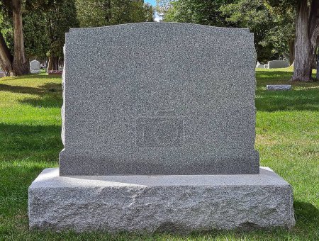 Blank gray granite tombstone in a cemetery 