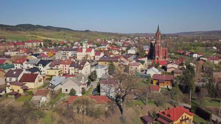 Photo for Panorama from a bird's eye view. Central Europe: The Polish town of Kolaczyce is located among the green hills. Temperate climate. Flight drones or quadrocopter. aerial view of a tourist city. - Royalty Free Image