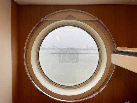 Photo pour View from round ferry window at port city near the seashore - image libre de droit
