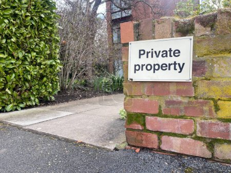 Photo for Private property sign on a brick wall covered in moss - Royalty Free Image