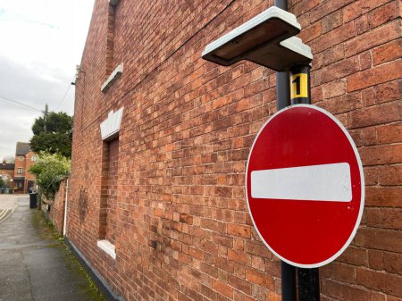 Photo for Red no entry for vehicular traffic sign near brick wall in old town - Royalty Free Image