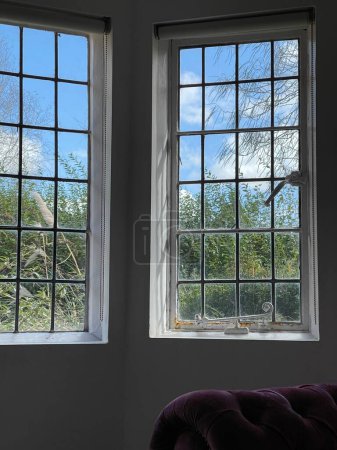 Photo for Beautiful sunny spring weather seen through old fashioned windows in a house - Royalty Free Image