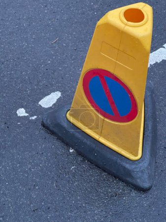 Photo for Close up of a yellow traffic cone with no waiting sign - Royalty Free Image