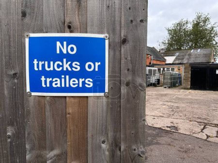 Photo for No trucks or trailers sign on a wooden fence - Royalty Free Image