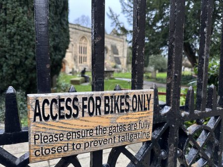 Photo for Wooden sign plaque access for bikes only on parkland gate - Royalty Free Image