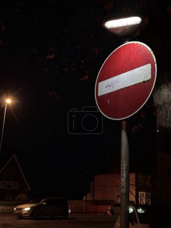 Photo for Vertical shot of no entry traffic sign illuminated at night - Royalty Free Image