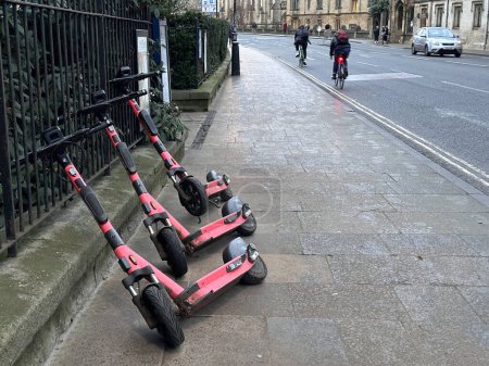 Photo for Three pink electric scooters in a row on the street - Royalty Free Image