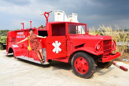 Photo for Thai woman posing with old red fire truck - Royalty Free Image