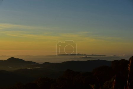 Foto de Hermoso cielo y nubes doradas, montañas antes del amanecer. Mira desde lo alto de la colina. - Imagen libre de derechos