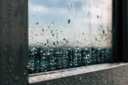 raindrops flow down the window glass. closeup of raindrops