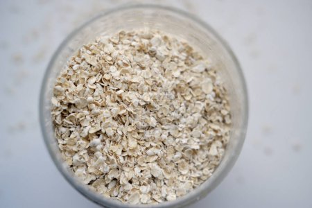 Photo for Glass jar with oatmeal close-up. top view of a jar of oatmeal - Royalty Free Image