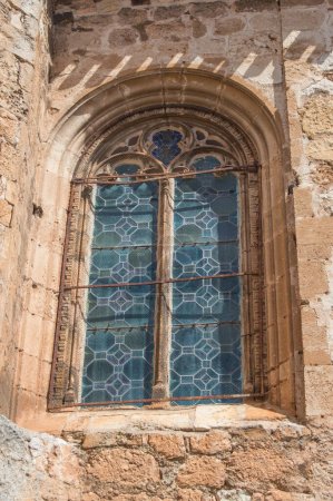 Photo for Exterior of gothic window with stained glass on a stone facade - Royalty Free Image