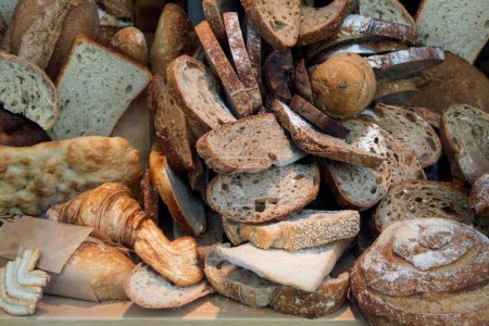 different types of breads in the shopping window of a bakery