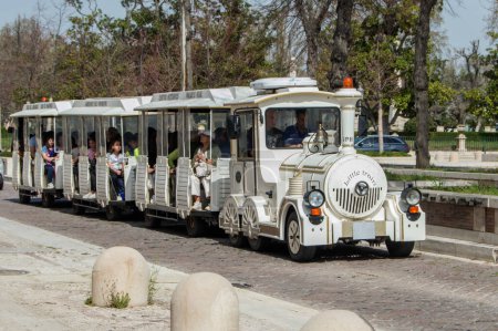 Photo for Small white tourist train that runs through the streets of Aranjuez, province of Madrid. Spain - Royalty Free Image